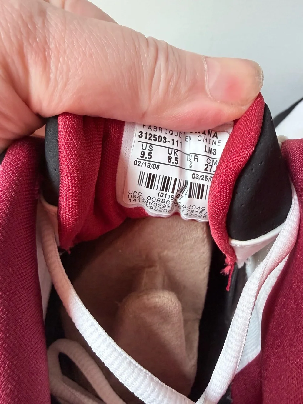 Nike Jordan Team Reign Low sneakers in a white, black, and red colorway,